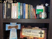 a book shelf with a bible, a cross, and other items